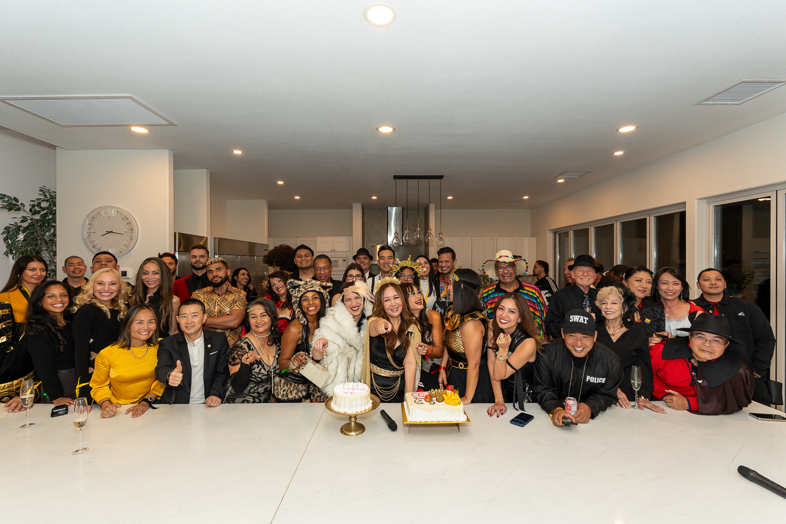 Friends cheering together around REFC's first-anniversary cake