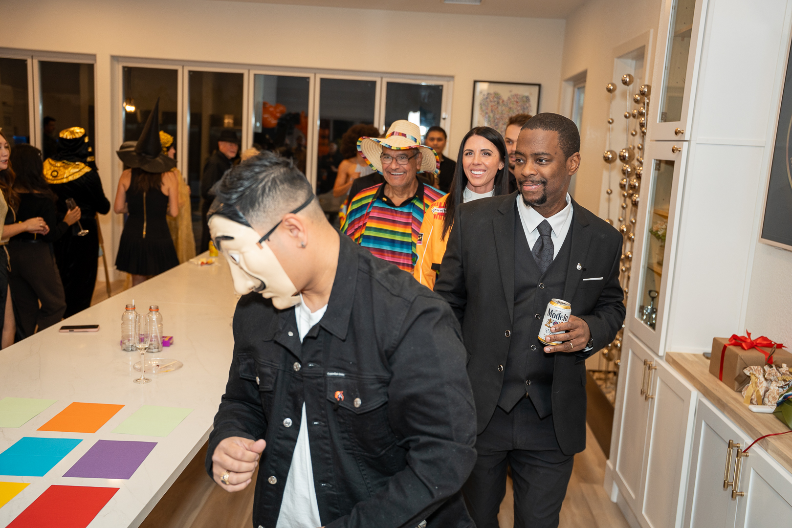 Costumed guests laughing and enjoying drinks during the REFC anniversary mixer