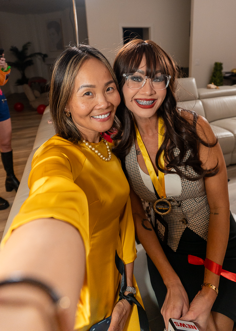 Two smiling friends taking a selfie at the REFC Halloween Mixer