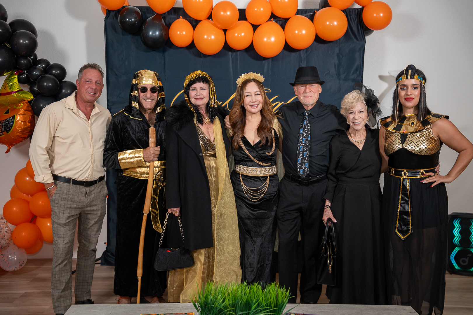 Costumed friends gathered for a group portrait at the Real Estate Friends Club backdrop