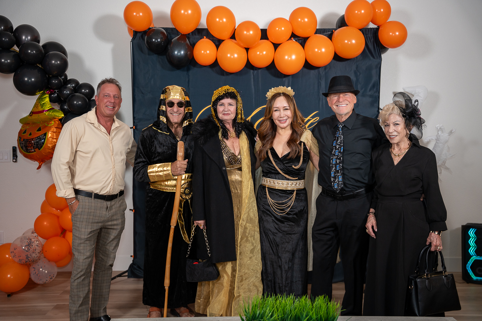 A group of costumed guests at the REFC step-and-repeat