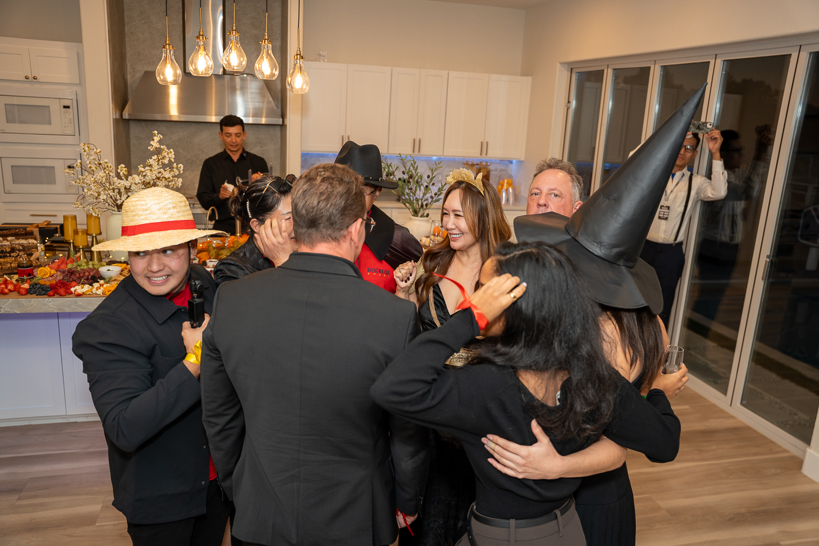 Costumed friends sharing a group embrace at the REFC Halloween mixer