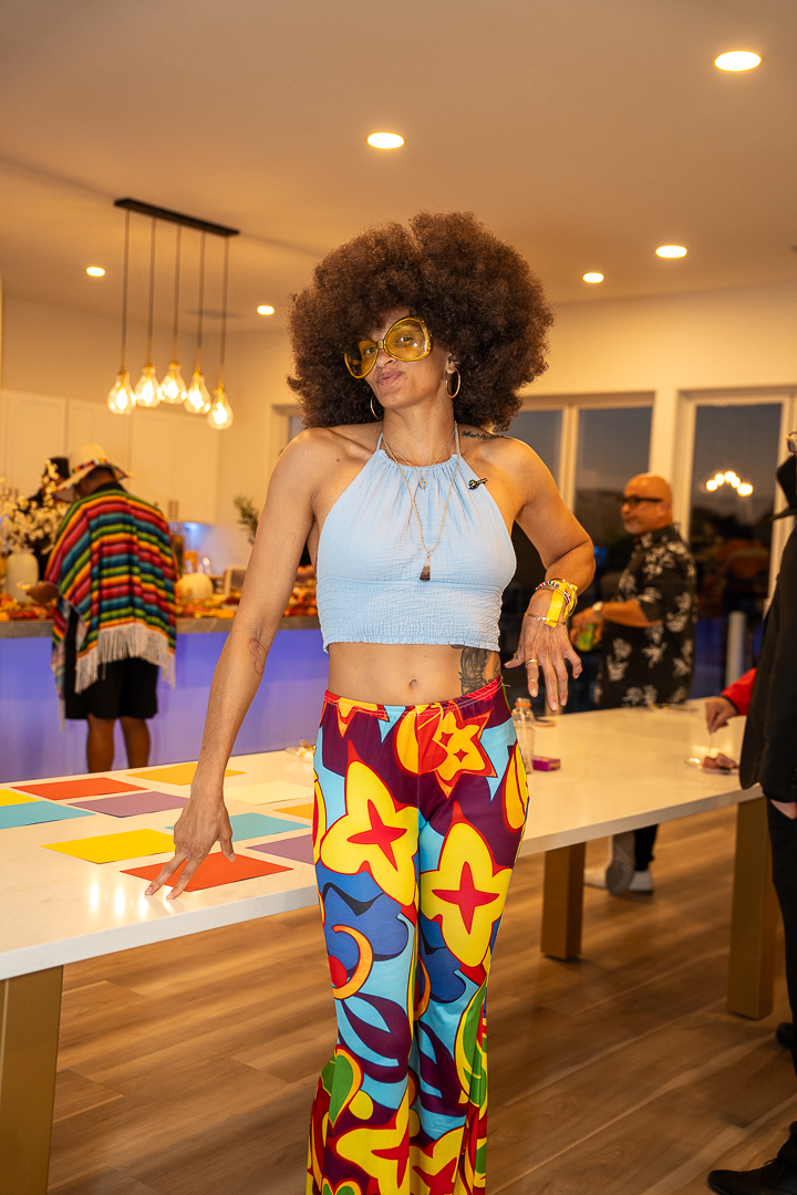 A guest in a disco-inspired costume enjoying the REFC Halloween Mixer