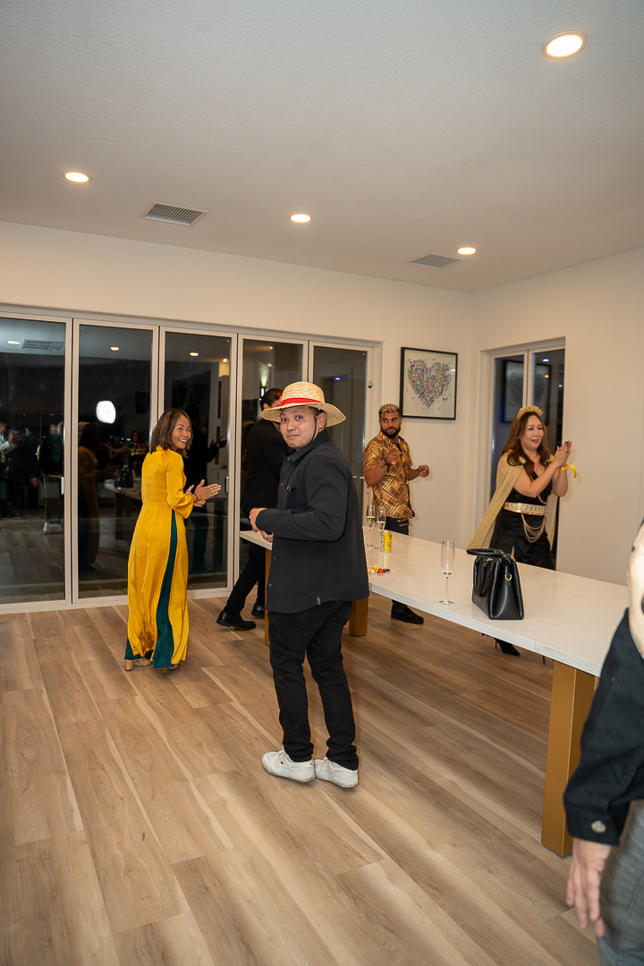 Guests in colorful Halloween costumes gathering on the dance floor