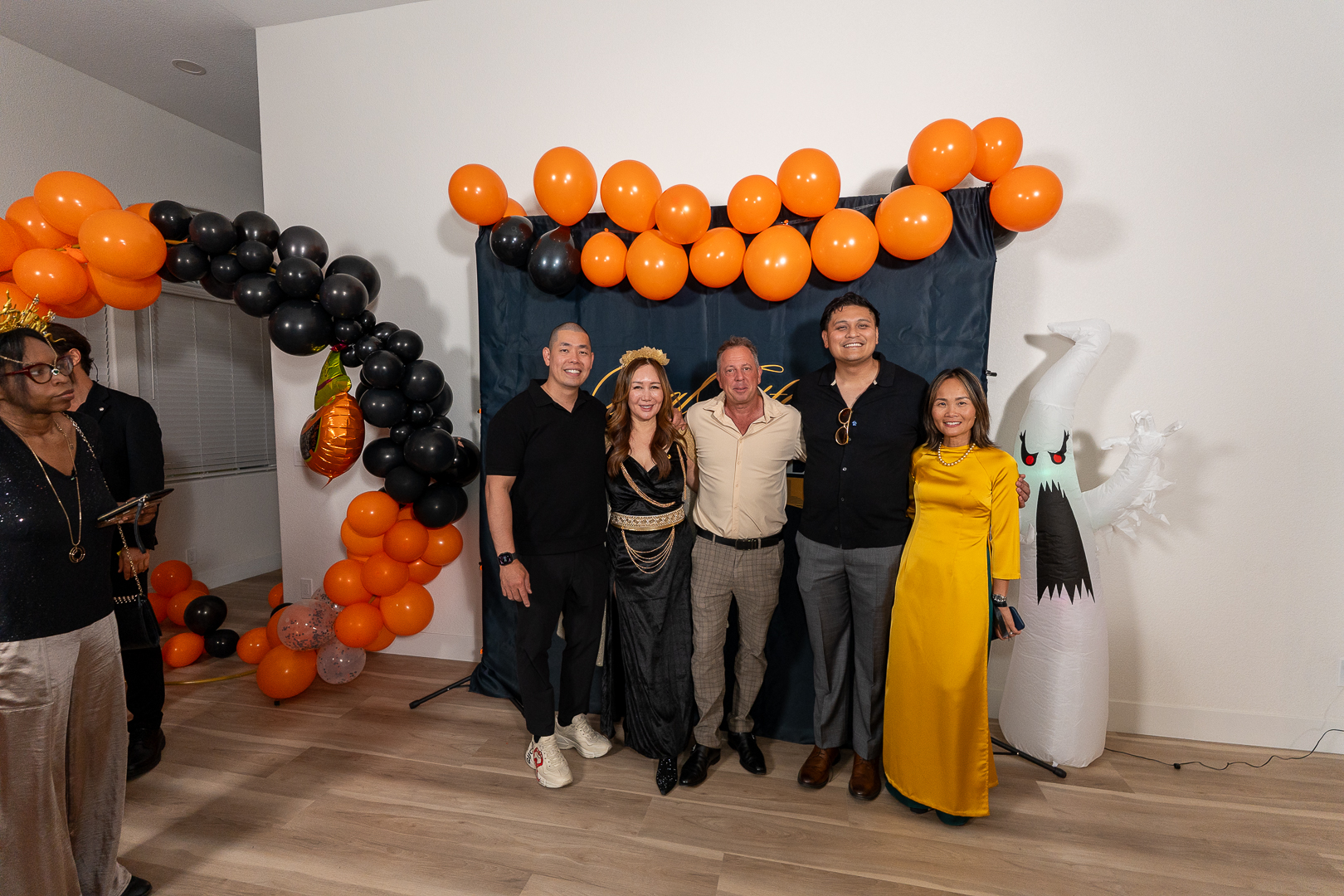 Friends posing for a group portrait at the Real Estate Friends Club backdrop