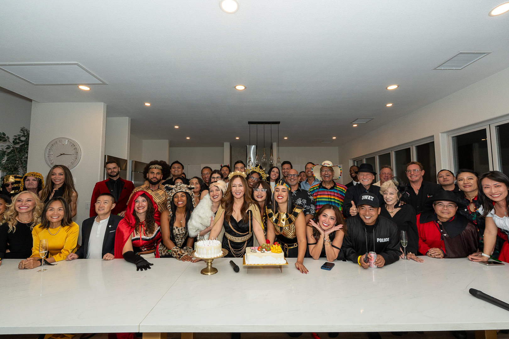 The REFC group smiling around the cake for the club's first anniversary