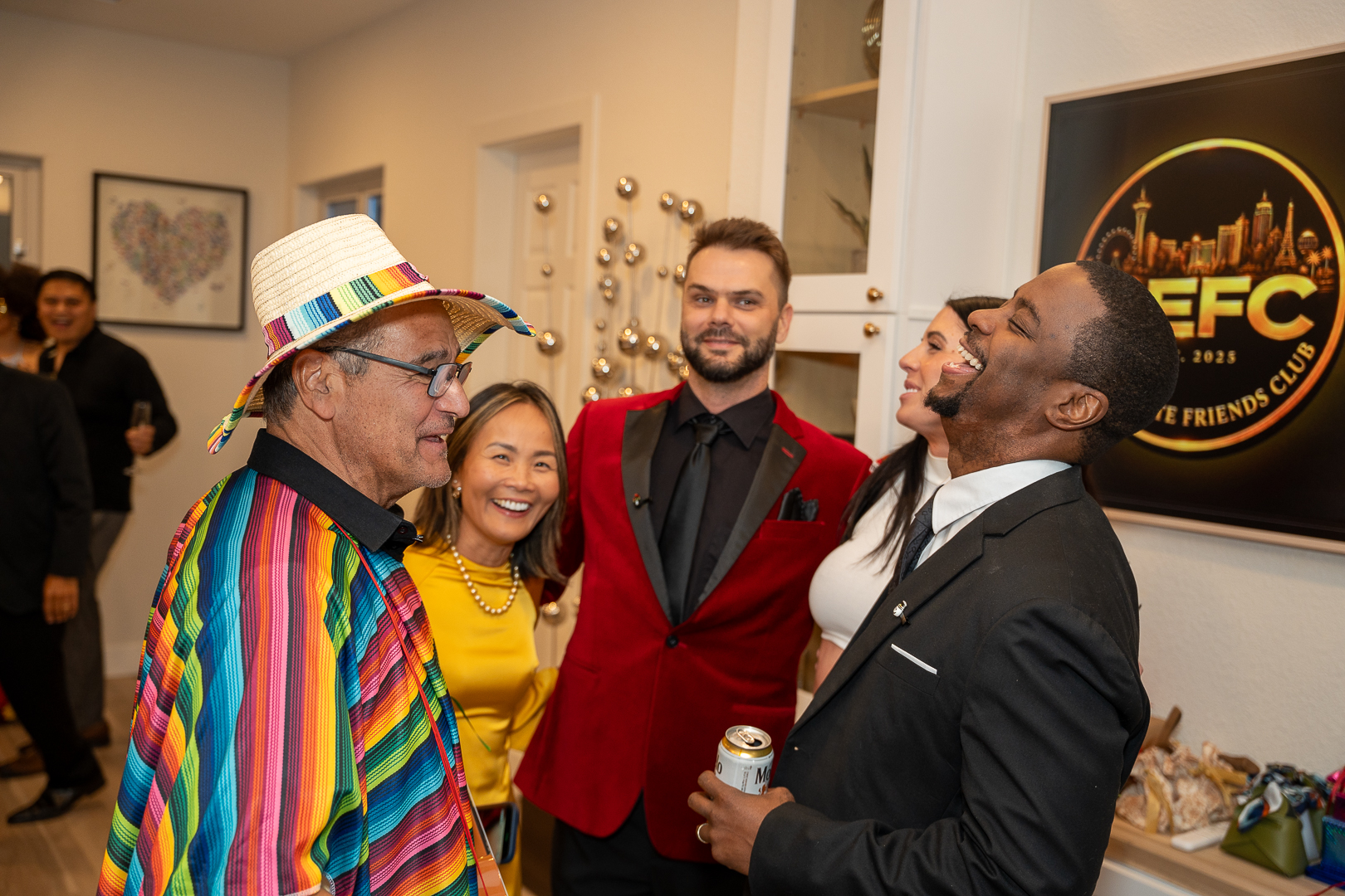 Costumed friends laughing together beside the refreshments