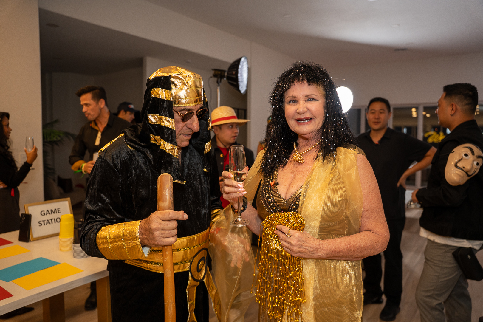 Costumed guests enjoying drinks and conversation at the REFC mixer