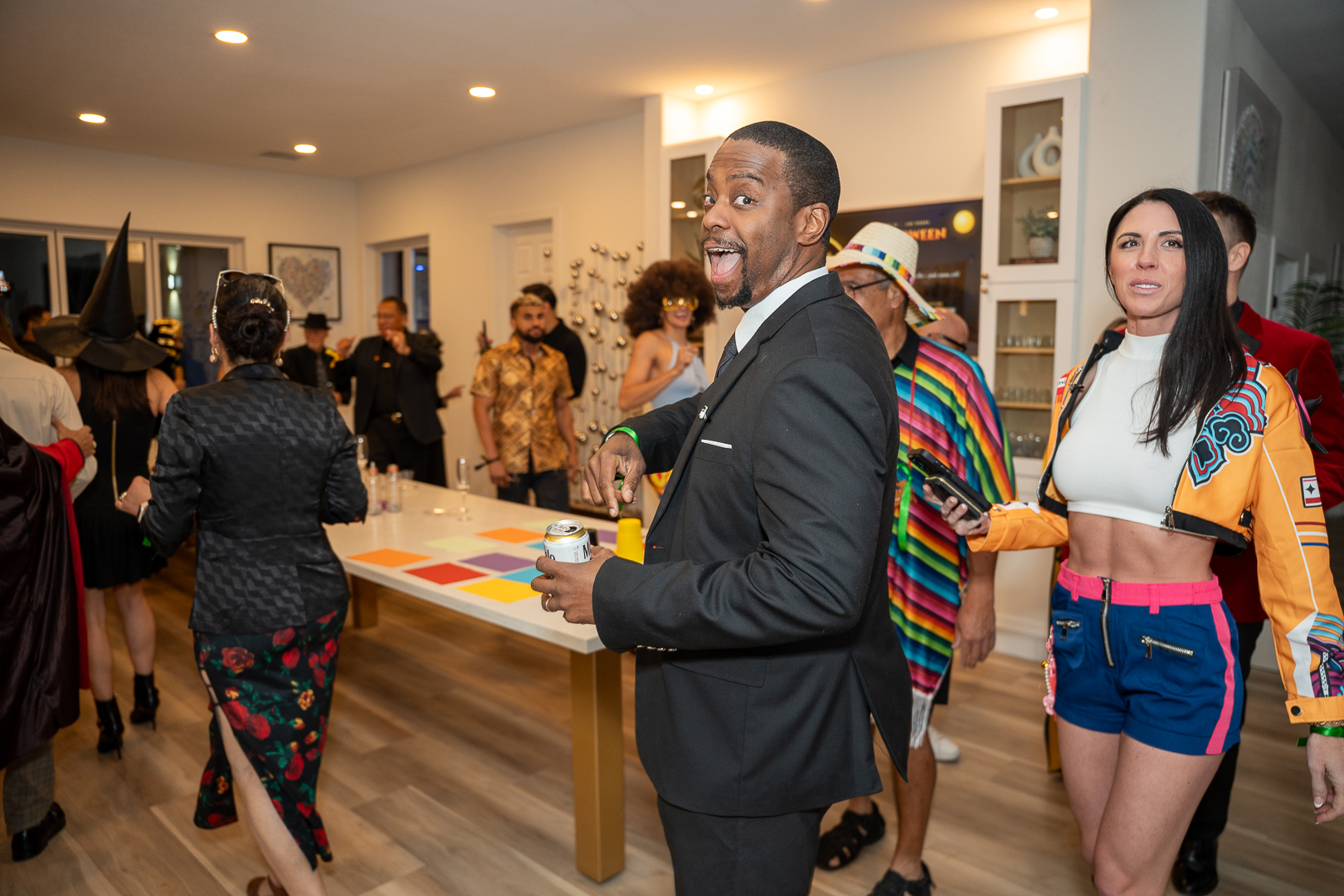 Guests chatting beside the kitchen island during the mixer