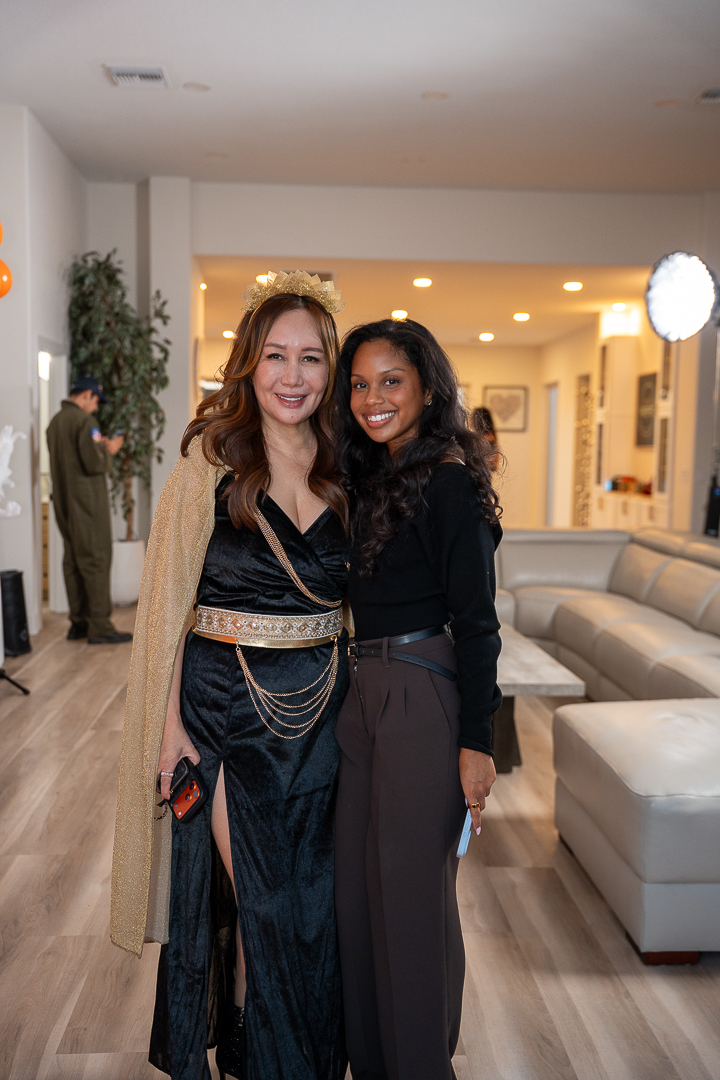 Two guests smiling together at the REFC Halloween Mixer