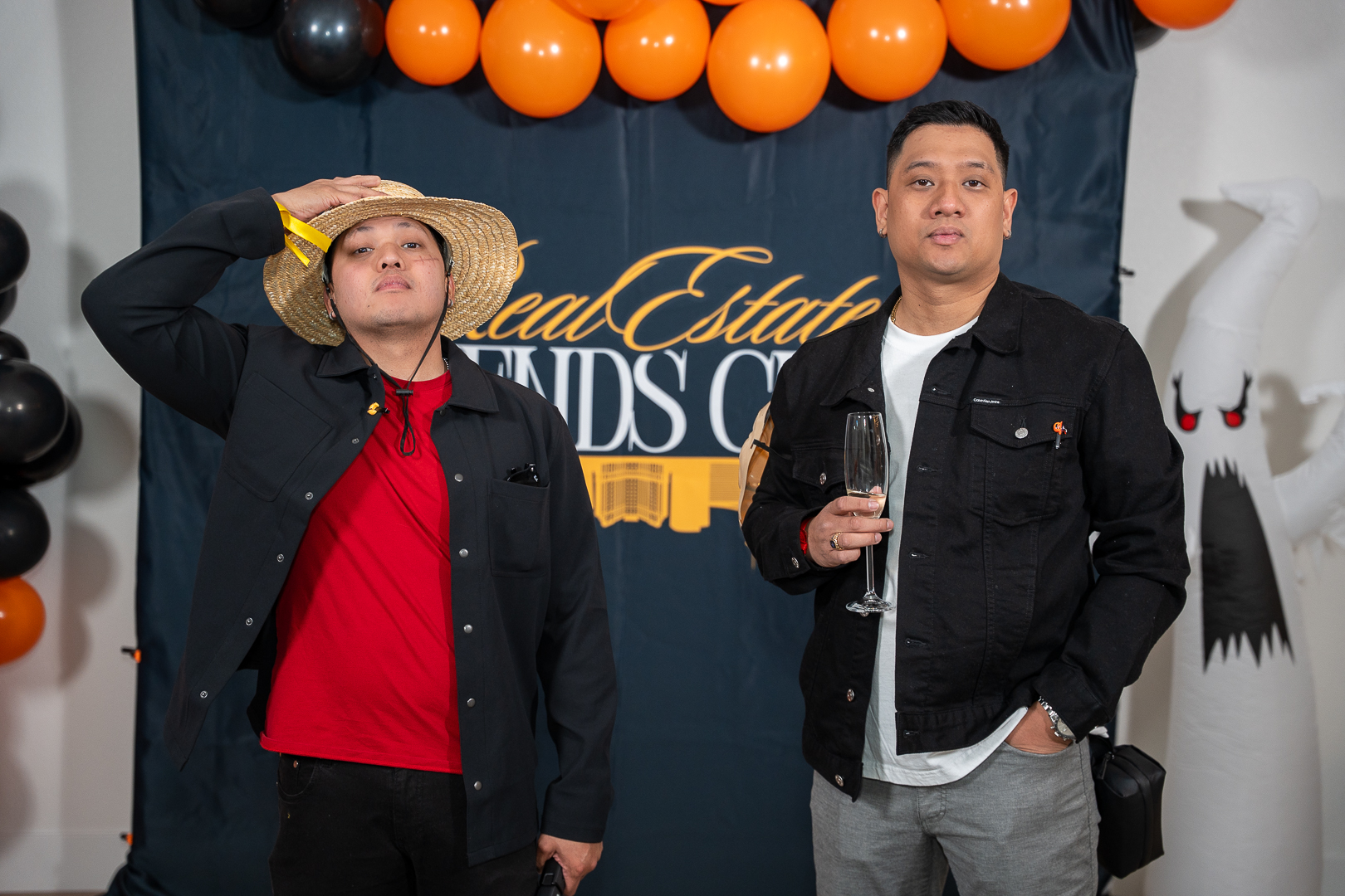 Guests in a cowboy costume and dark jacket posing at the REFC backdrop