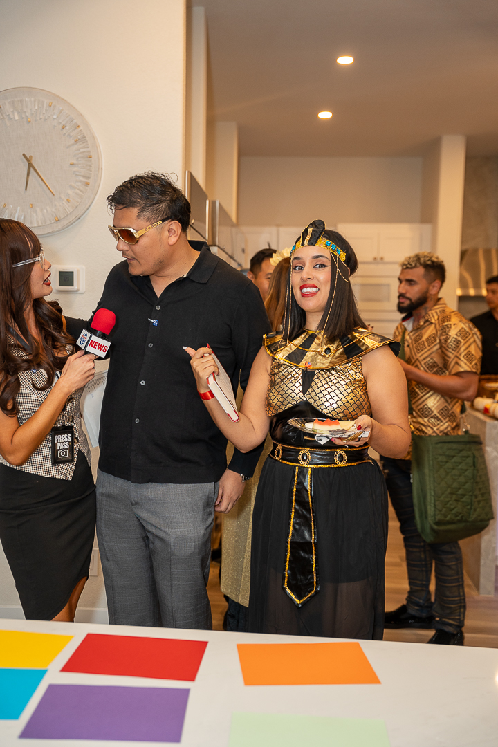 The reporter's interview at the kitchen island, microphone in hand