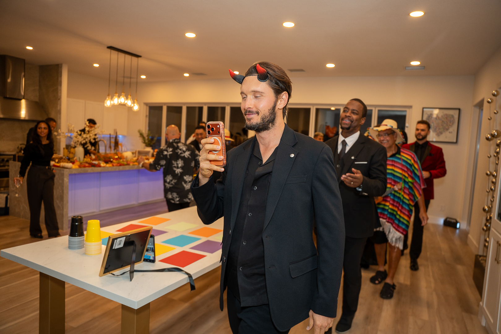 A guest in a dark suit raising a glass during the REFC celebration