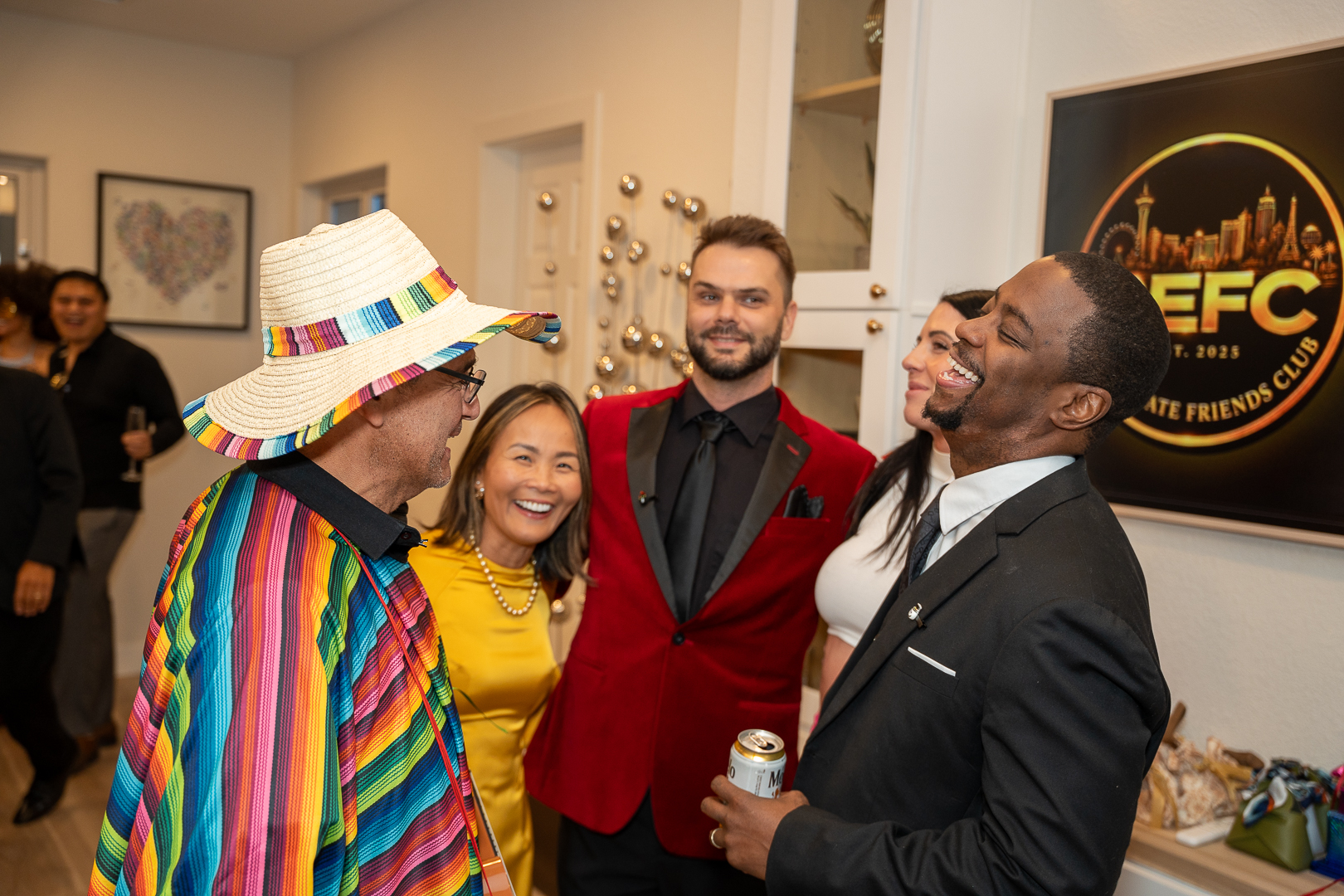 Friends in rainbow, yellow, and vampire costumes sharing a laugh