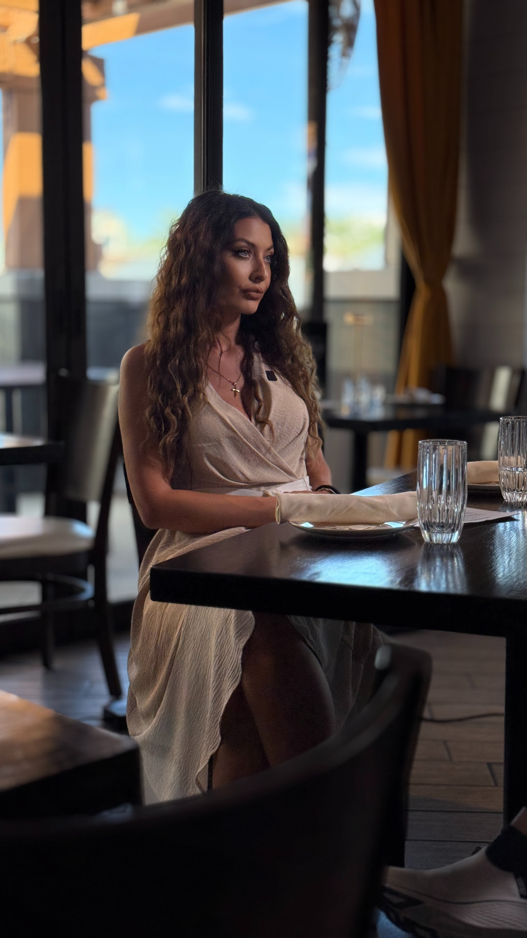 Catalina Magee, host of Meet My Vegas, seated in a Las Vegas restaurant