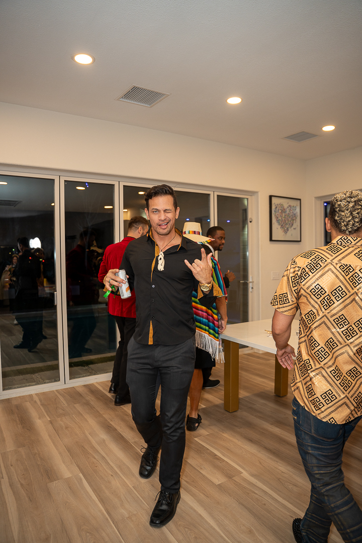 A smiling guest in a dark suit joining the REFC party celebration
