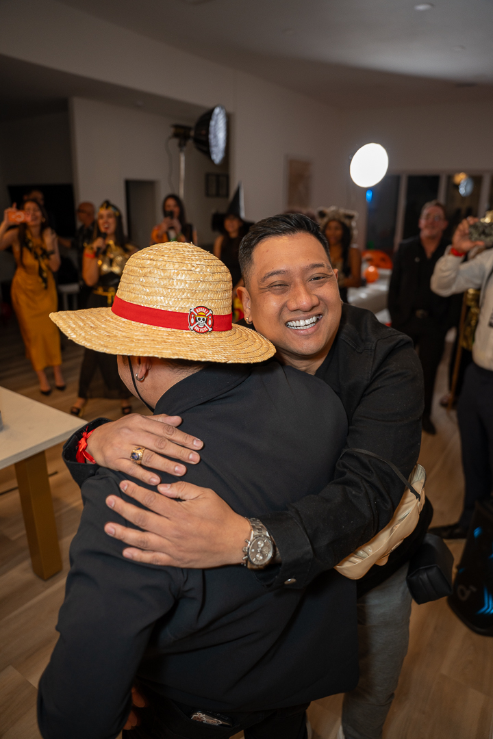 Two friends sharing a hug during the REFC anniversary mixer