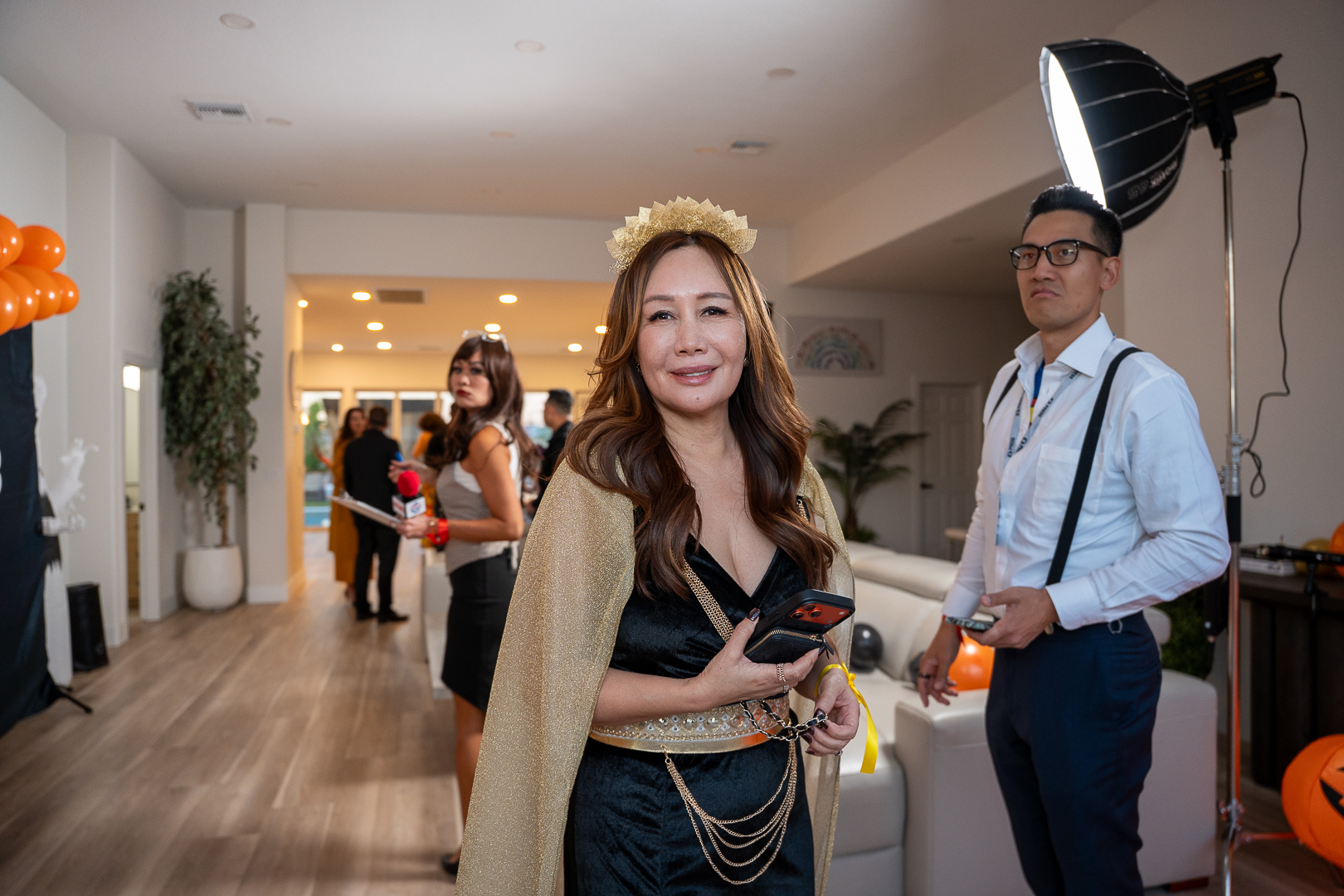 The queen-costumed hostess greeting guests in front of the REFC backdrop