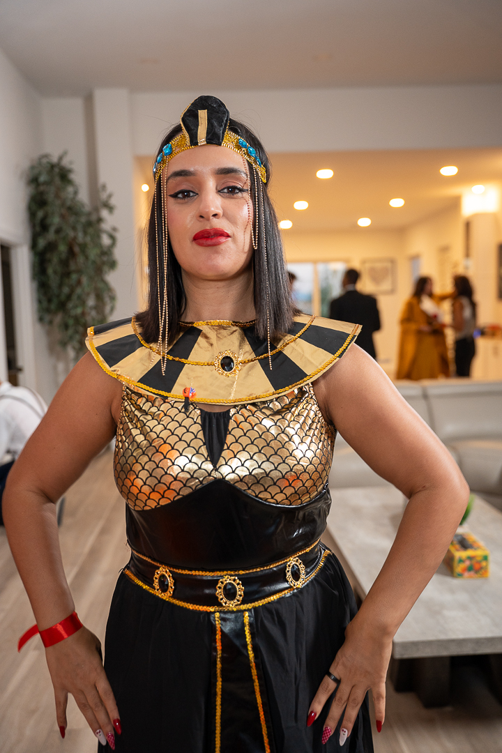 A guest in a full Egyptian pharaoh costume posing at the mixer