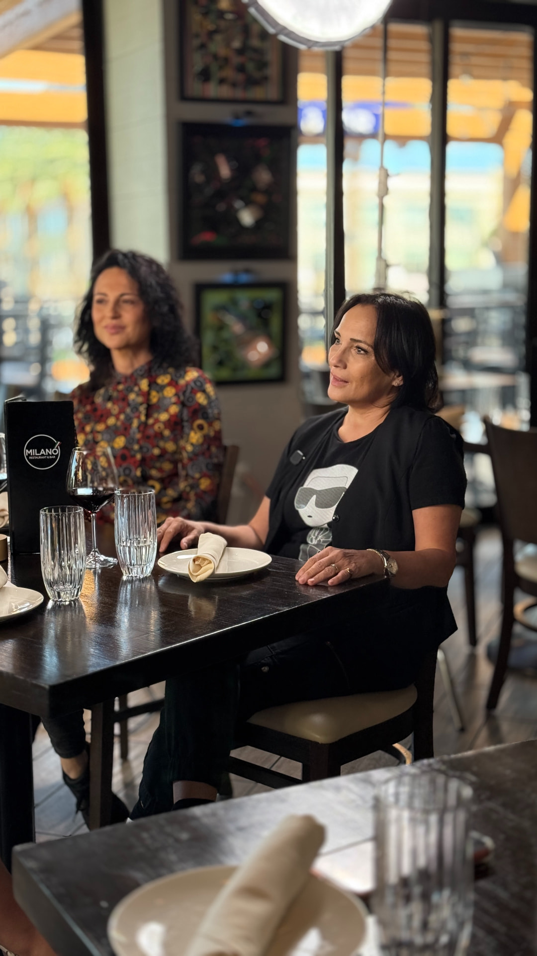 Guests seated at a table during the Milano shoot
