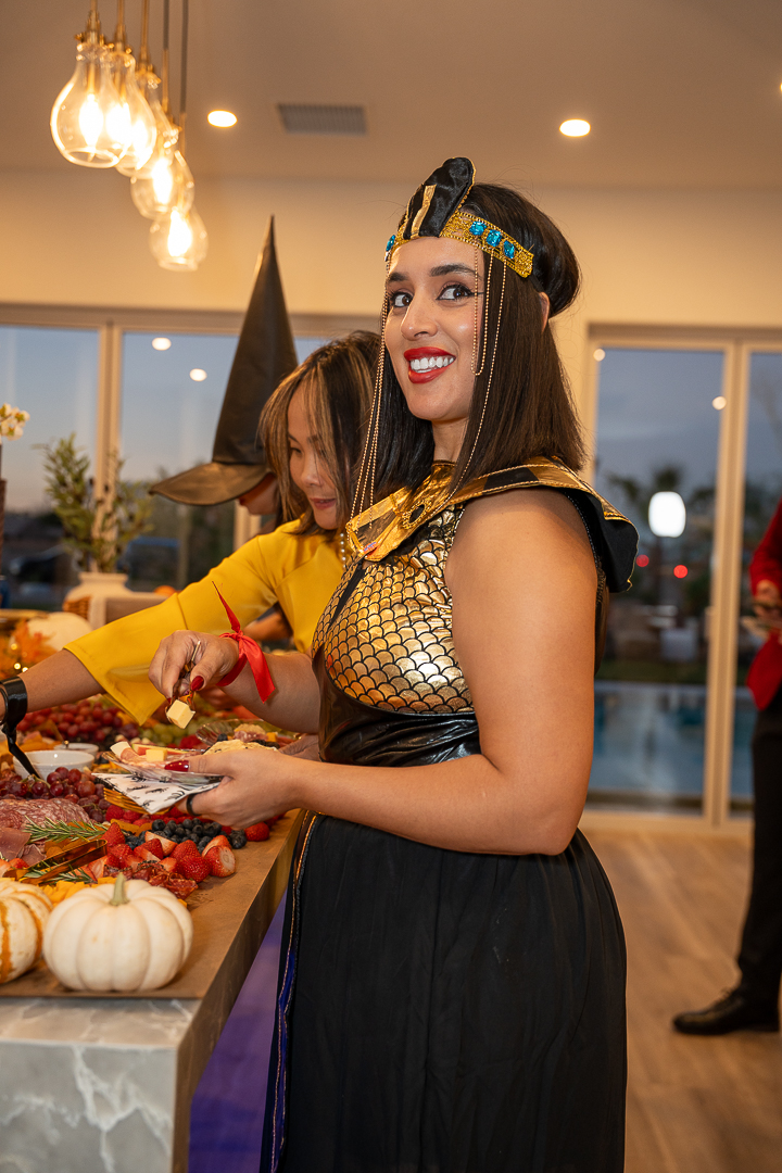 A guest in an Egyptian-inspired costume enjoying the grazing spread