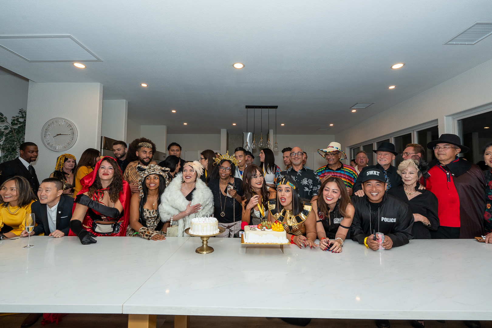 REFC members gathered around the kitchen island for a first-anniversary group photo