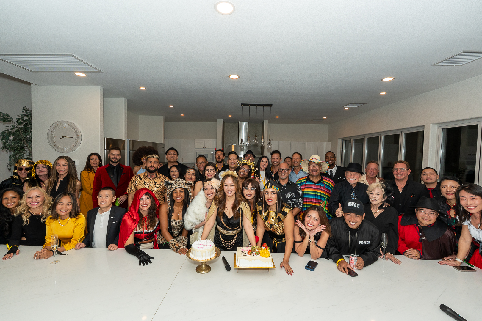 REFC members gathering for a large anniversary group portrait behind the kitchen island